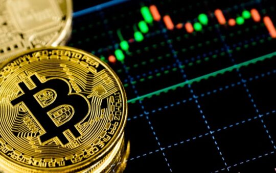 An image of stacked up bitcoins with trading chart