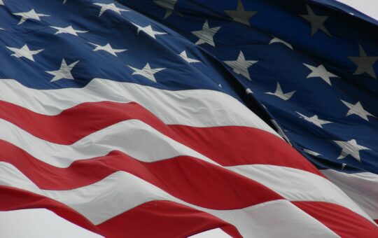 USA flag as OpenAI announces ChatGPT Gov, an AI chatbot aiming to modernise US government agencies with artificial intelligence.