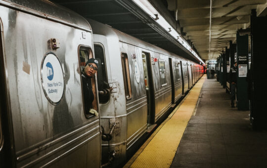 Image of commuters on a subway.