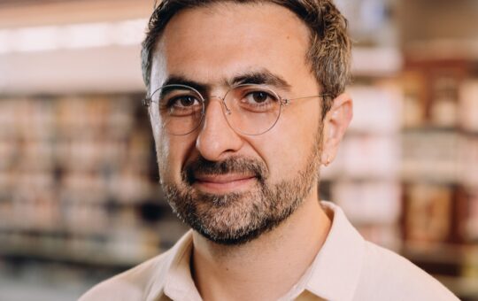 Photo of Microsoft AI CEO Mustafa Suleyman as he warns that Anthropic risks AI alignment failures by training Claude to view itself as a conscious entity deserving of legal rights.